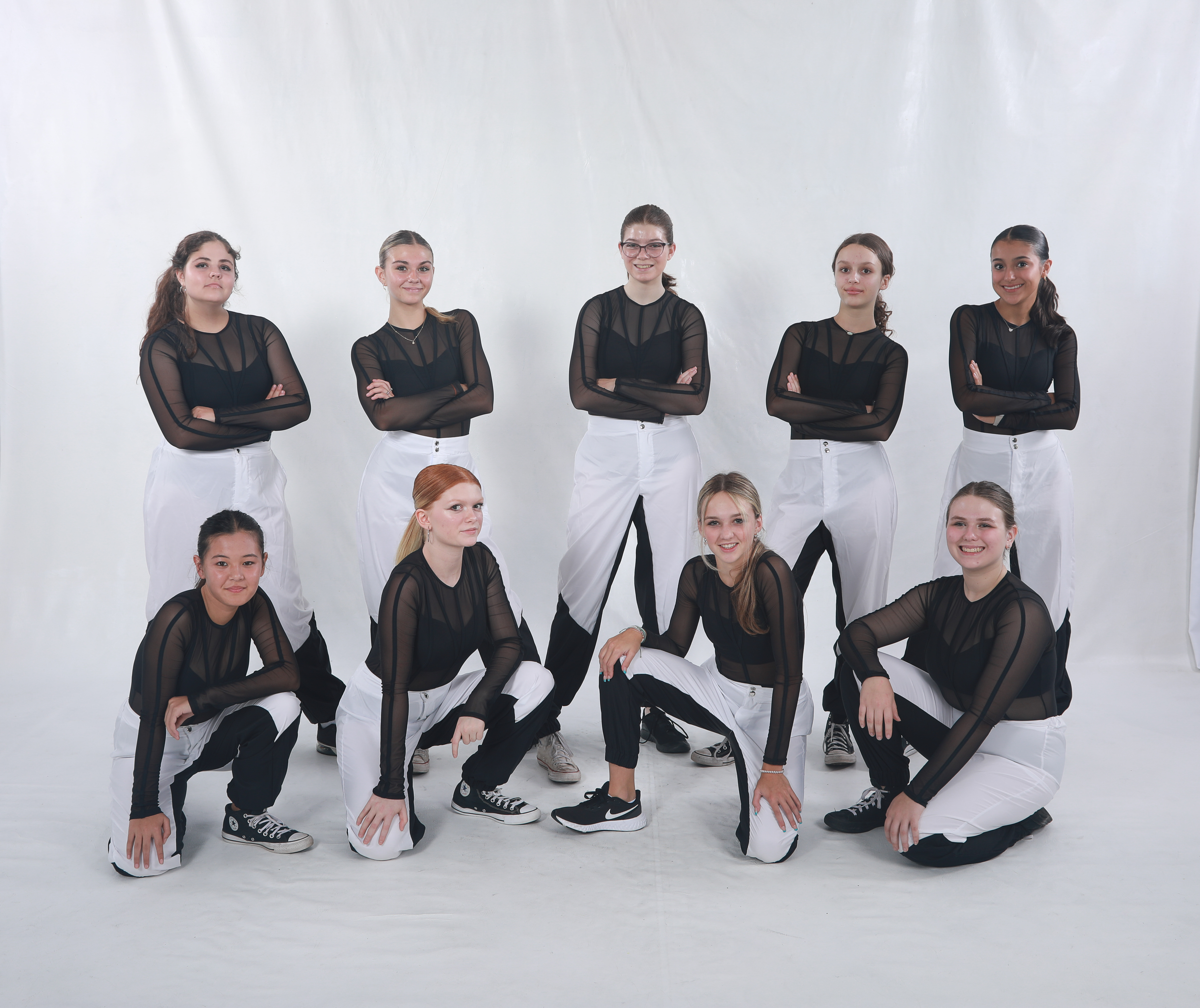 Stage Door Studios teen dancers posed in black-and-white performance outfits